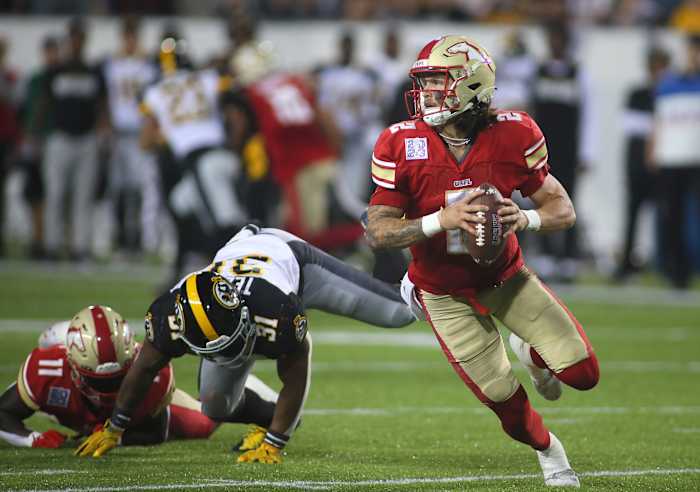 Birmingham Stallions Alex McGough (2) scrambles out of the pocket while being chased by Pittsburgh Maulers Kyahva Tezino (31) during the second half of the USFL Championship game Saturday evening at Tom Benson Stadium in Canton, OH.